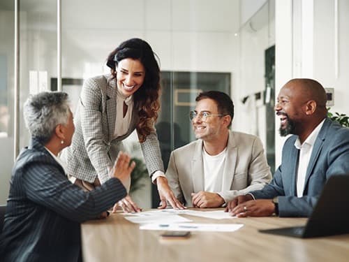 Group of diverse business professionals collaborating together in a modern office.