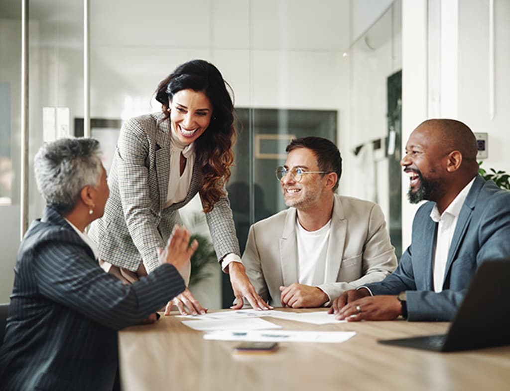 Group of diverse business professionals collaborating together in a modern office.